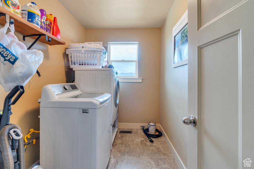 Clothes washing area with independent washer and dryer and baseboards