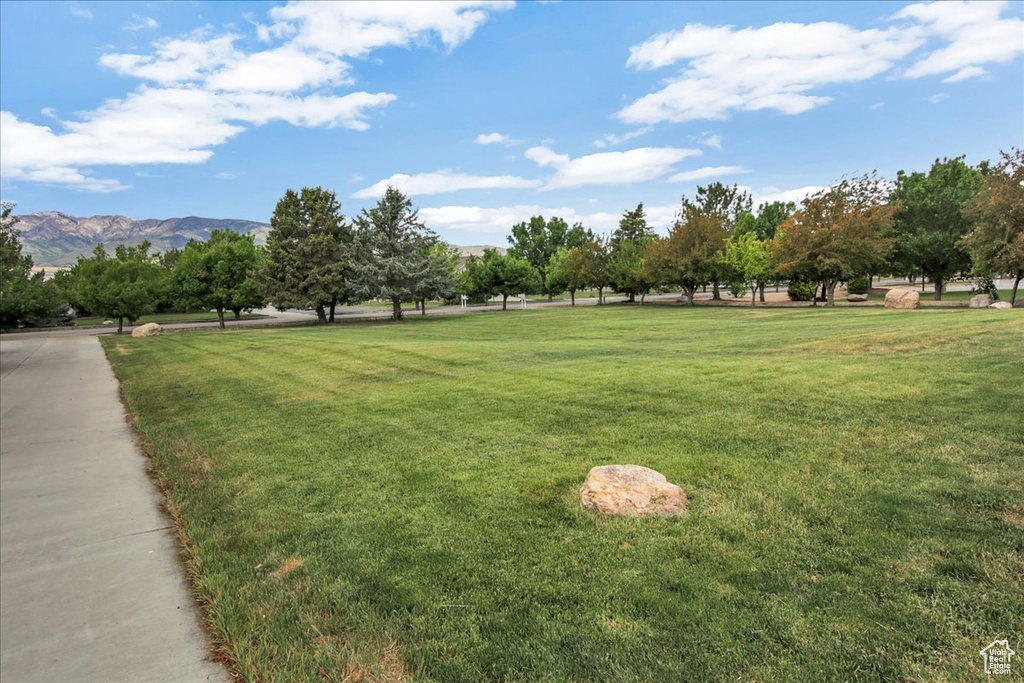 Surrounding community featuring a yard and a mountain view