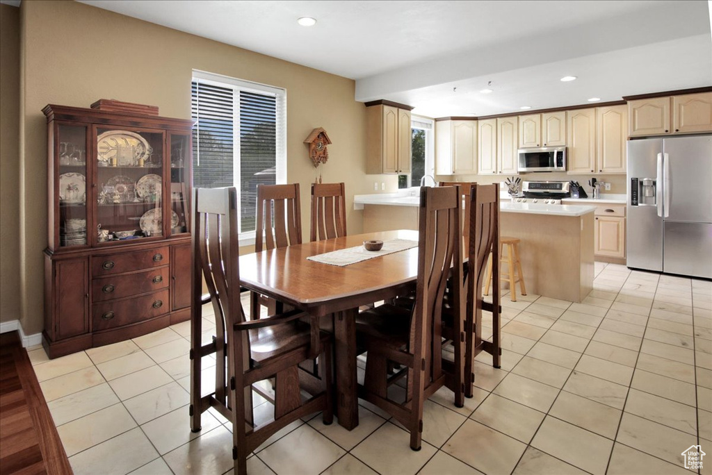 Dining space featuring recessed lighting and light tile patterned floors