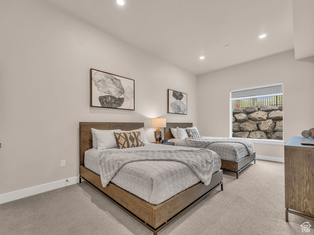 Bedroom featuring light colored carpet, recessed lighting, and baseboards