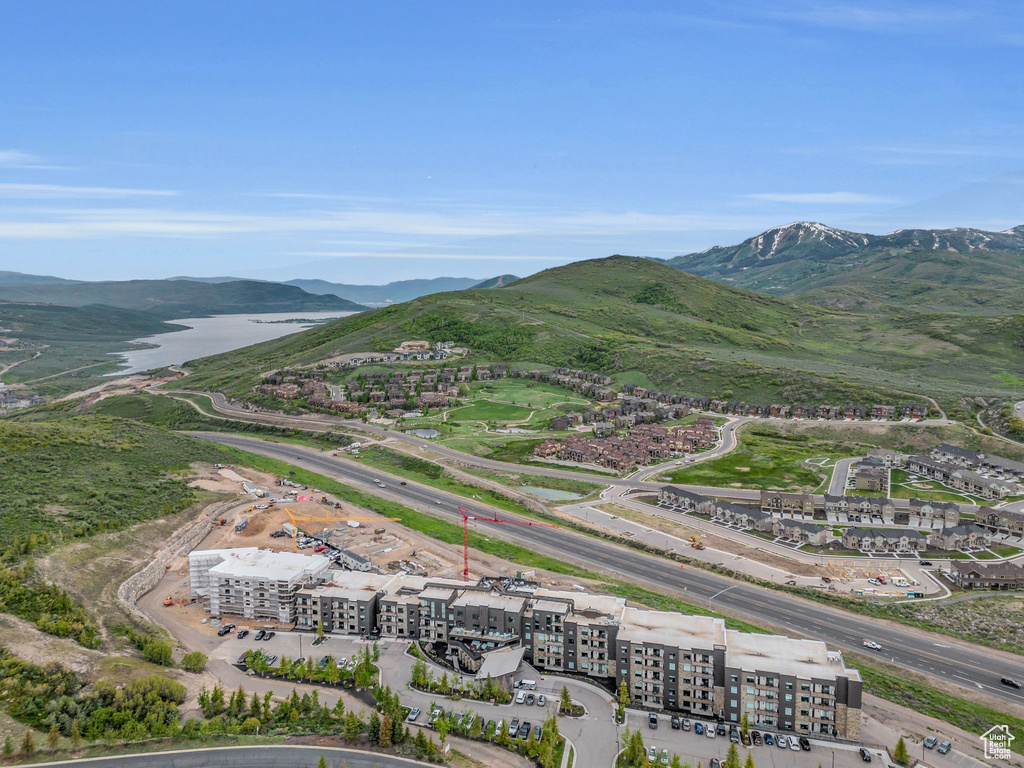 Drone / aerial view of a mountain backdrop and apartment complex / building