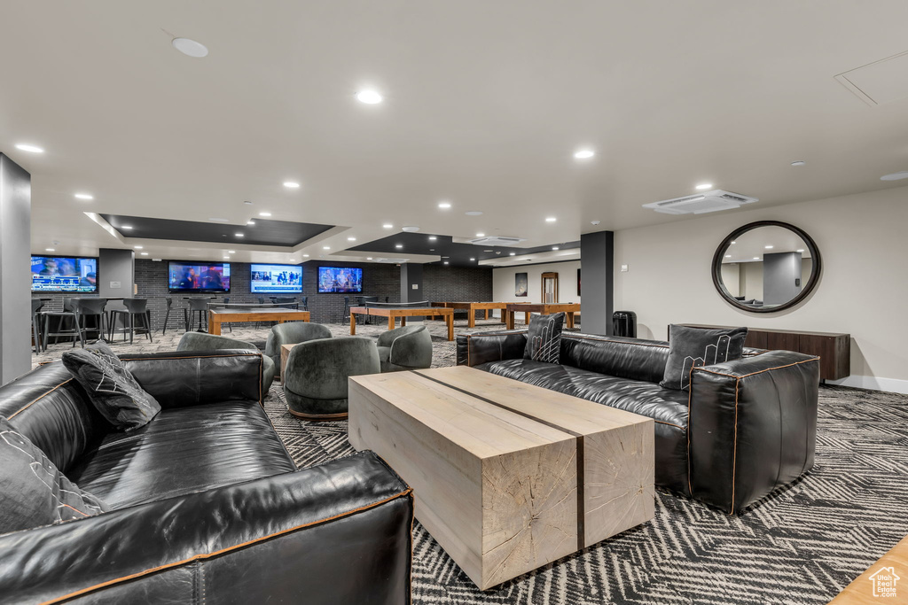 Living area with a community bar and recessed lighting