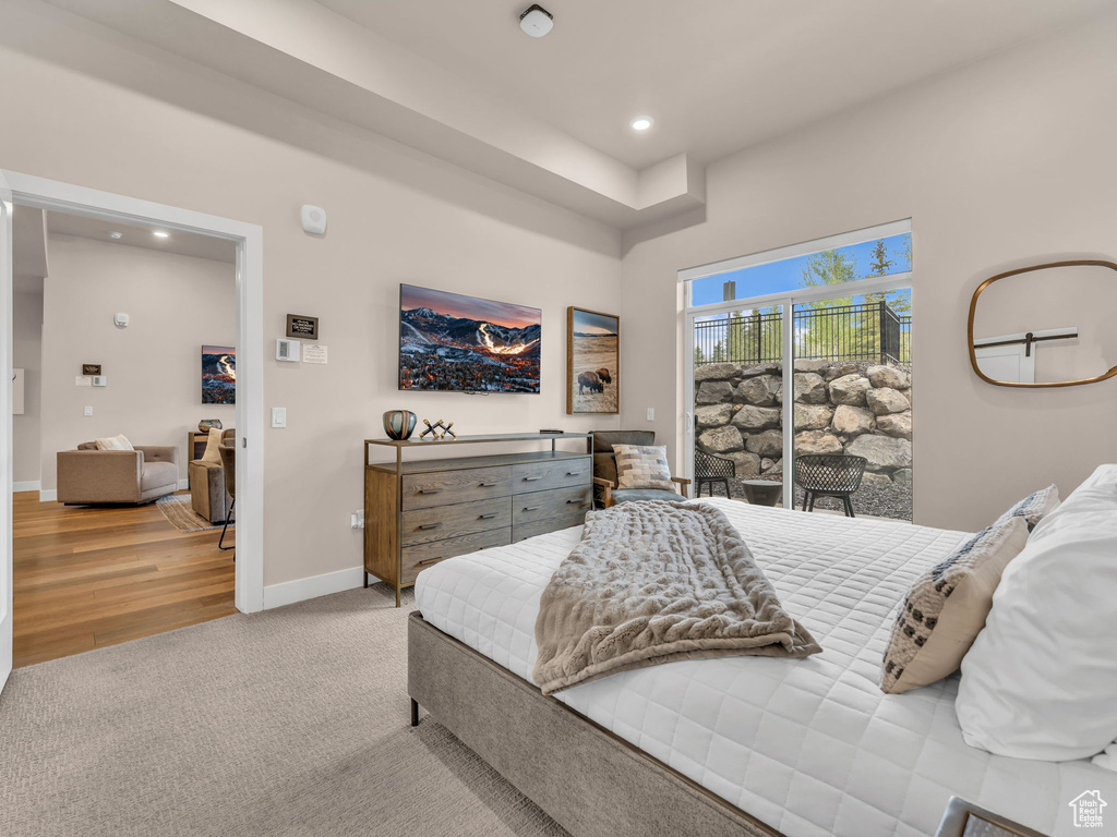 Bedroom featuring access to exterior, recessed lighting, carpet, baseboards, and wood finished floors
