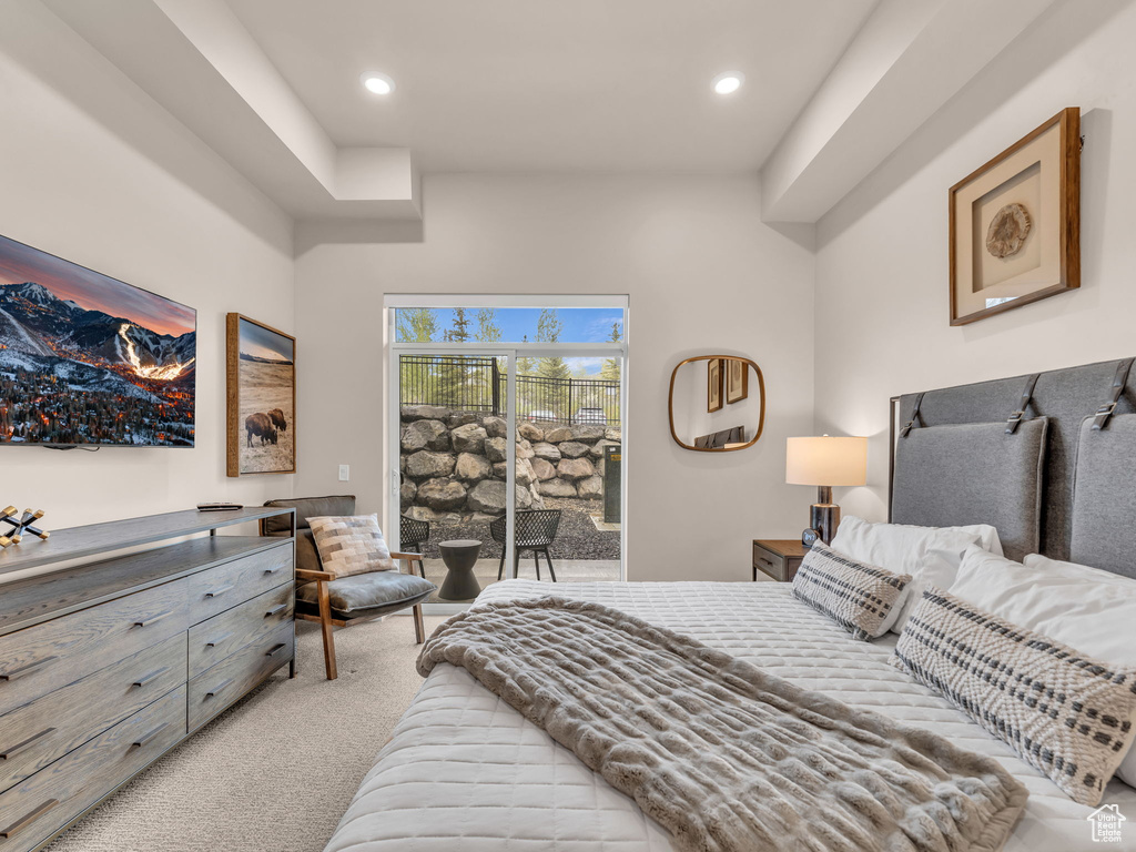 Bedroom featuring access to outside, light carpet, and recessed lighting