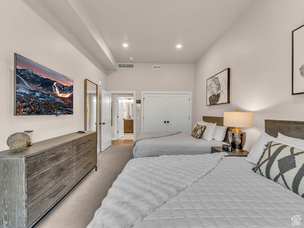 Bedroom featuring recessed lighting, carpet flooring, and ensuite bathroom