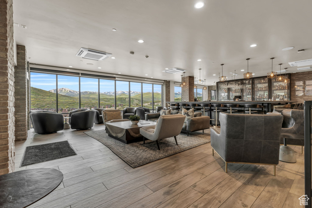 Living room featuring a wall of windows and wood finished floors