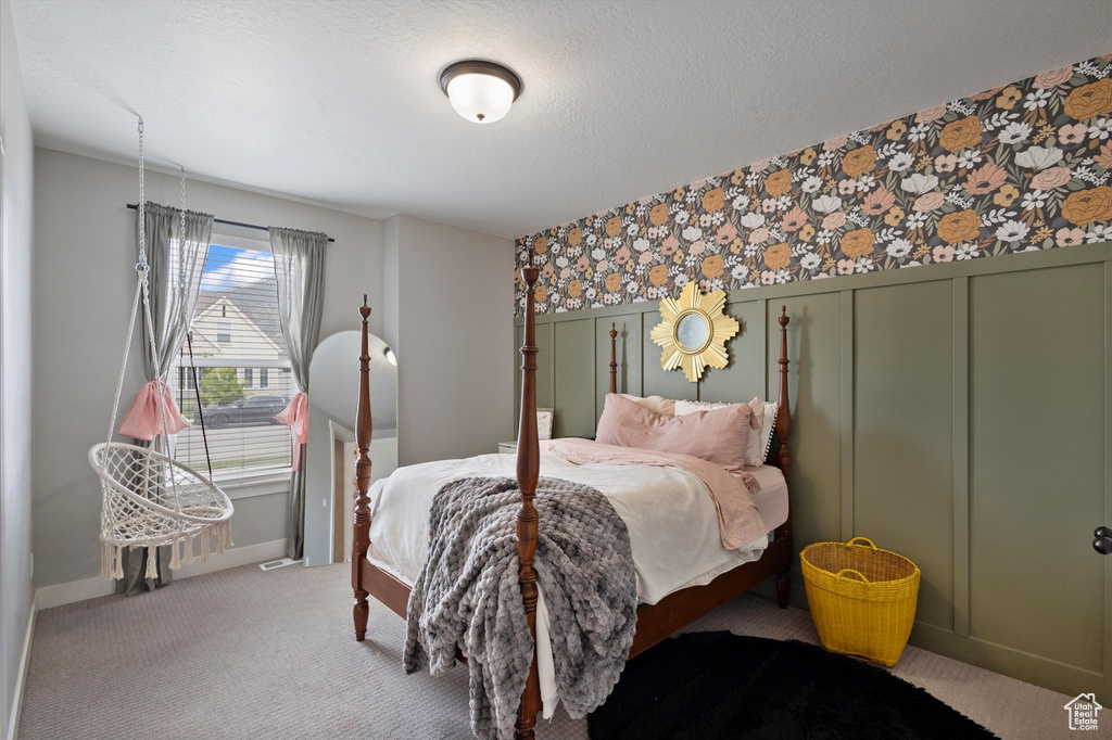 Bedroom featuring wallpapered walls, carpet, and baseboards
