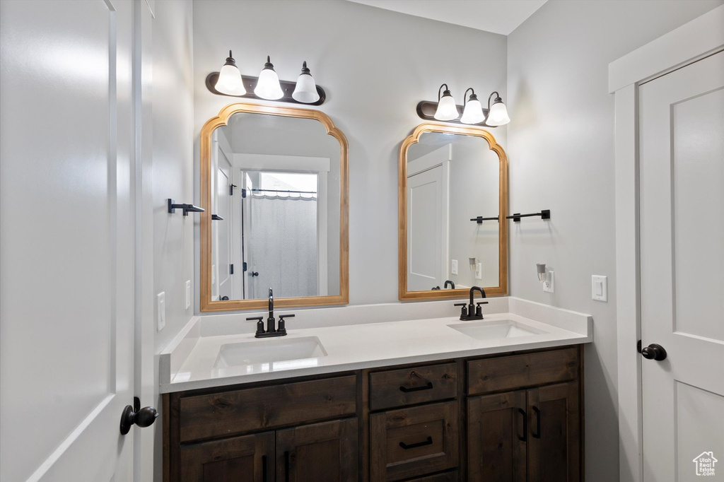 Full bath featuring double vanity