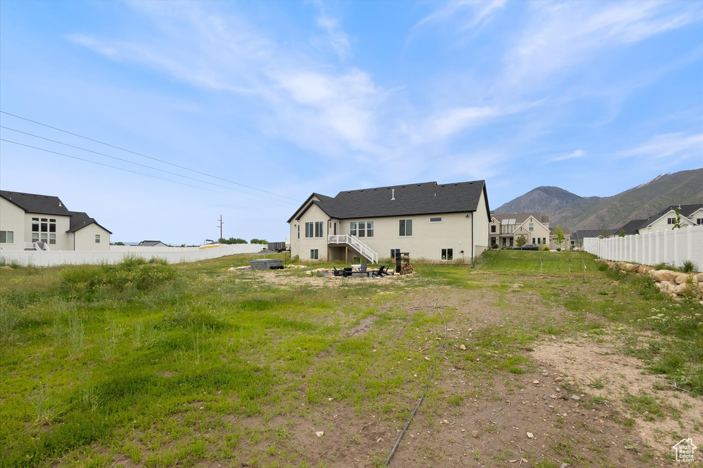 Back of house featuring fence and a mountain view
