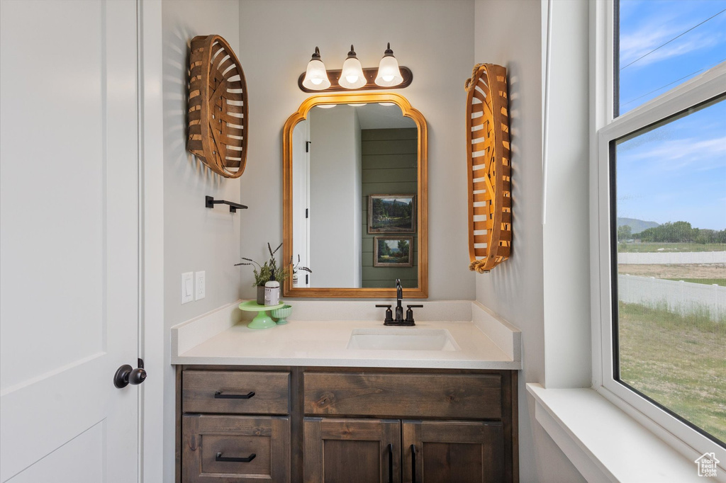 Bathroom featuring plenty of natural light and vanity