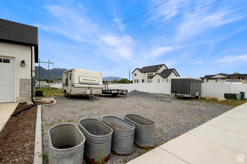 View of yard with a mountain view and fence