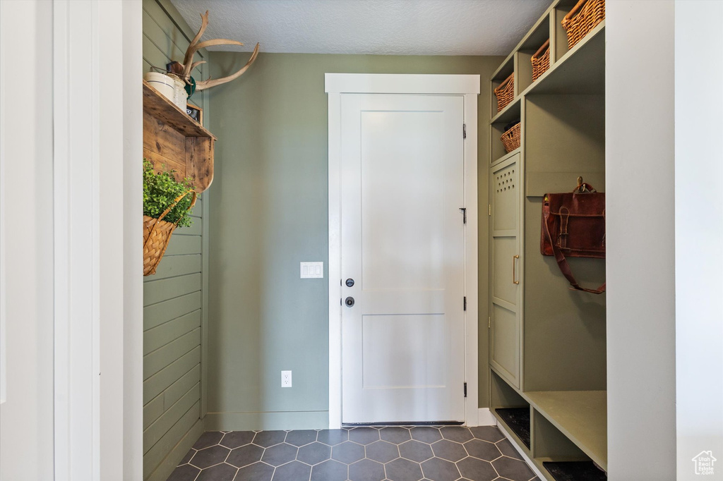 Mudroom with dark tile patterned flooring