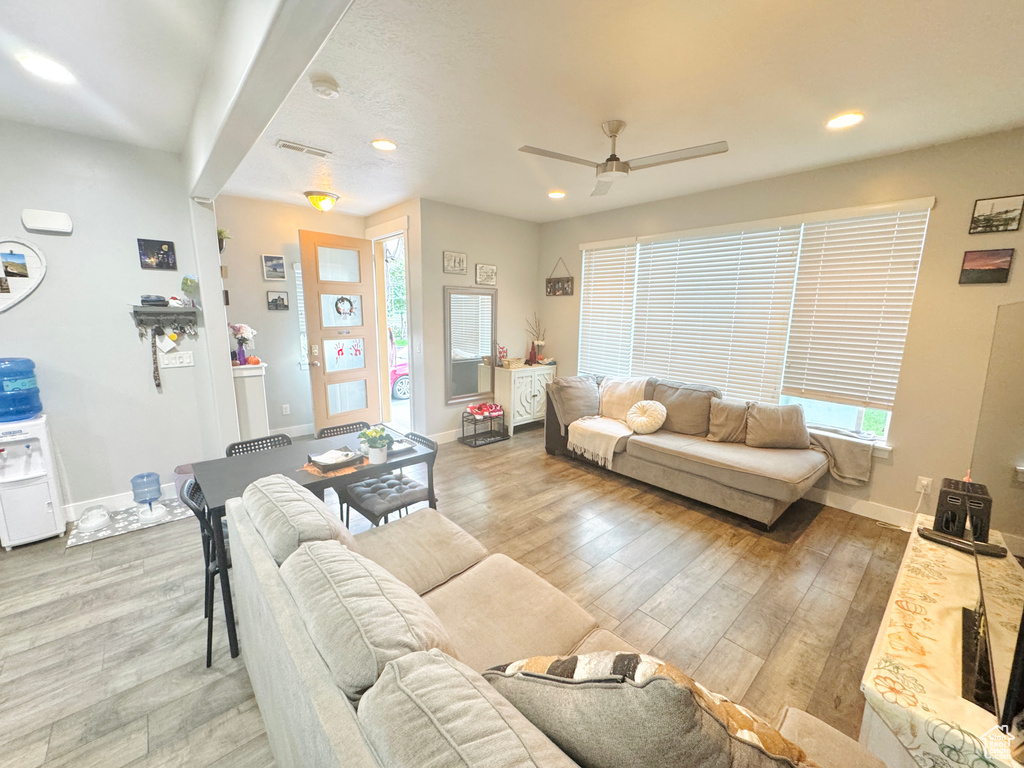 Living room featuring recessed lighting, wood finished floors, a ceiling fan, and baseboards
