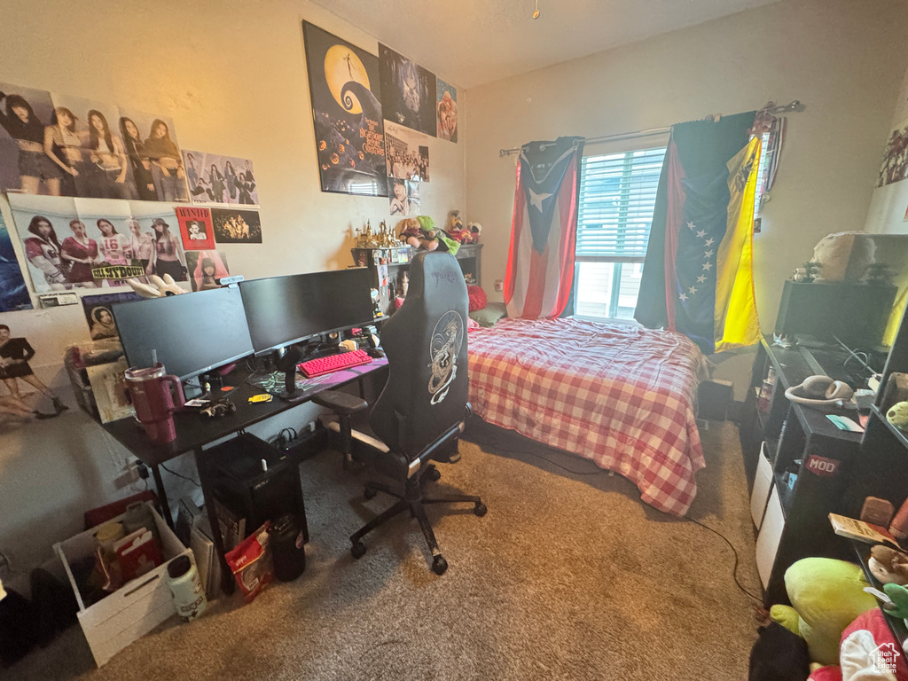 Bedroom featuring carpet flooring and a desk