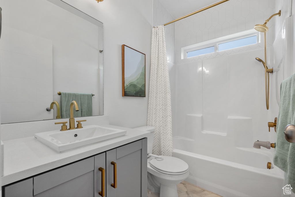 Full bath with toilet, shower / bathtub combination with curtain, and vanity