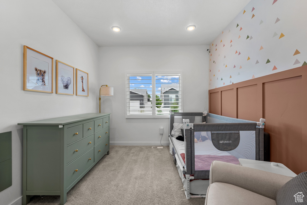 Bedroom featuring light carpet, wallpapered walls, baseboards, and recessed lighting