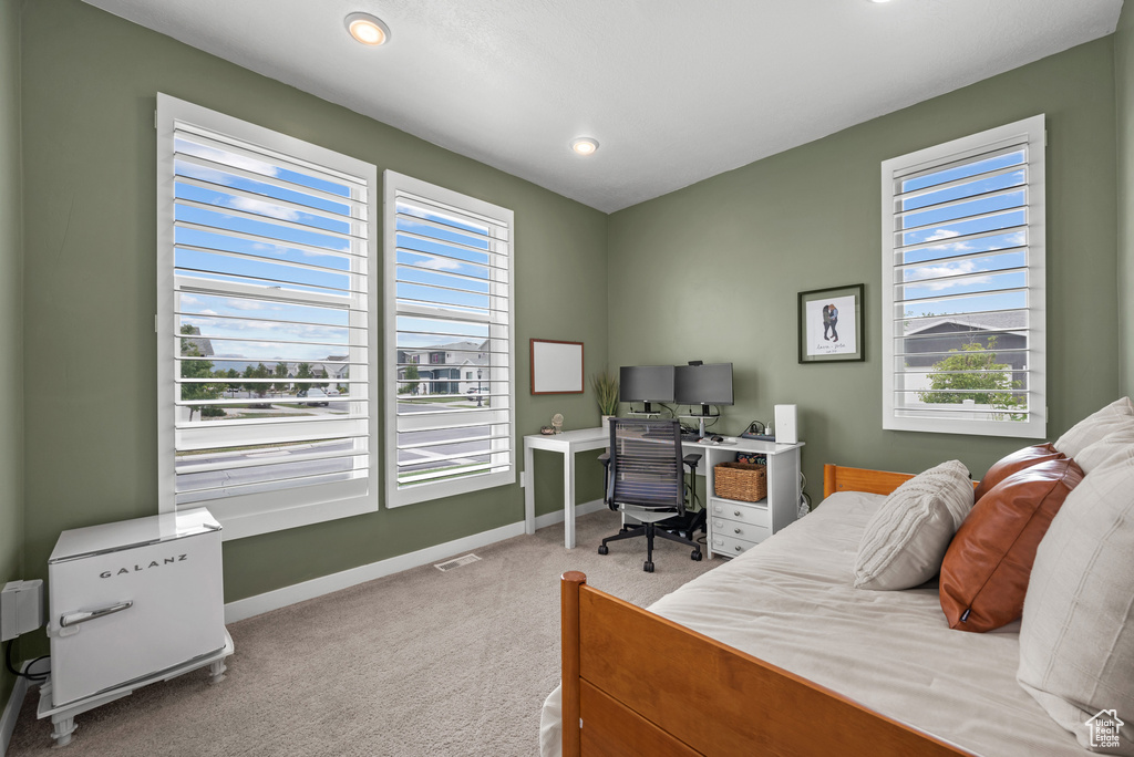 Carpeted bedroom with baseboards, an office area, and recessed lighting