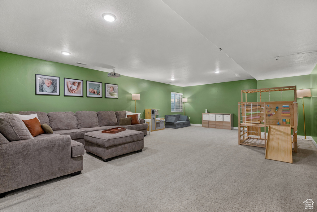 Carpeted living area featuring baseboards and recessed lighting