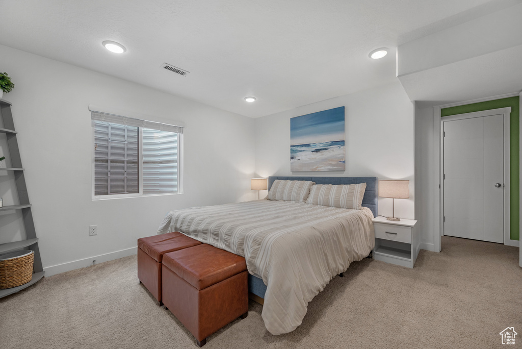 Bedroom featuring light carpet, baseboards, and recessed lighting