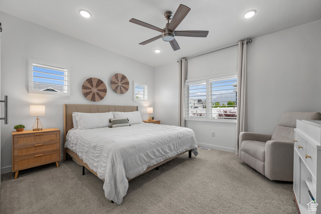 Bedroom with light colored carpet, recessed lighting, baseboards, and a ceiling fan