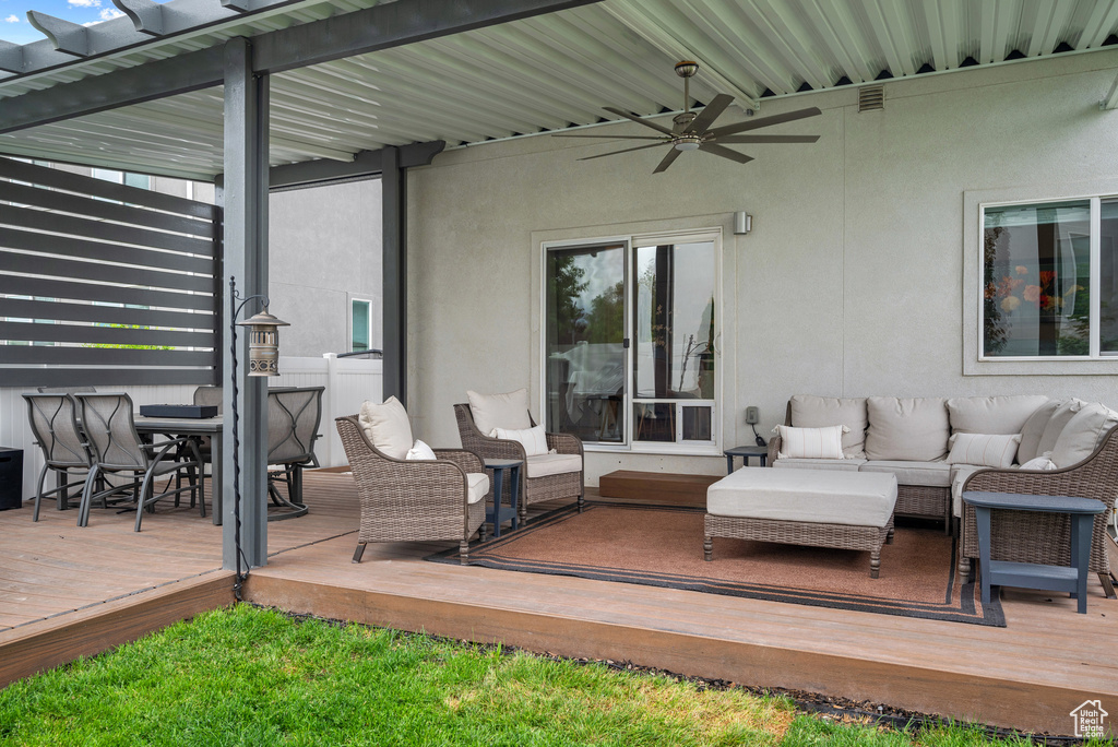 View of patio / terrace with an outdoor living space, a ceiling fan, a wooden deck, and outdoor dining area