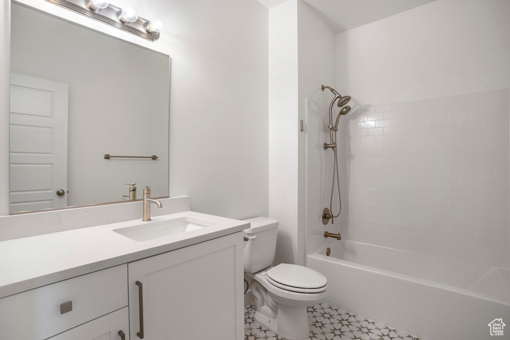 Full bath with toilet, vanity, and shower / tub combination