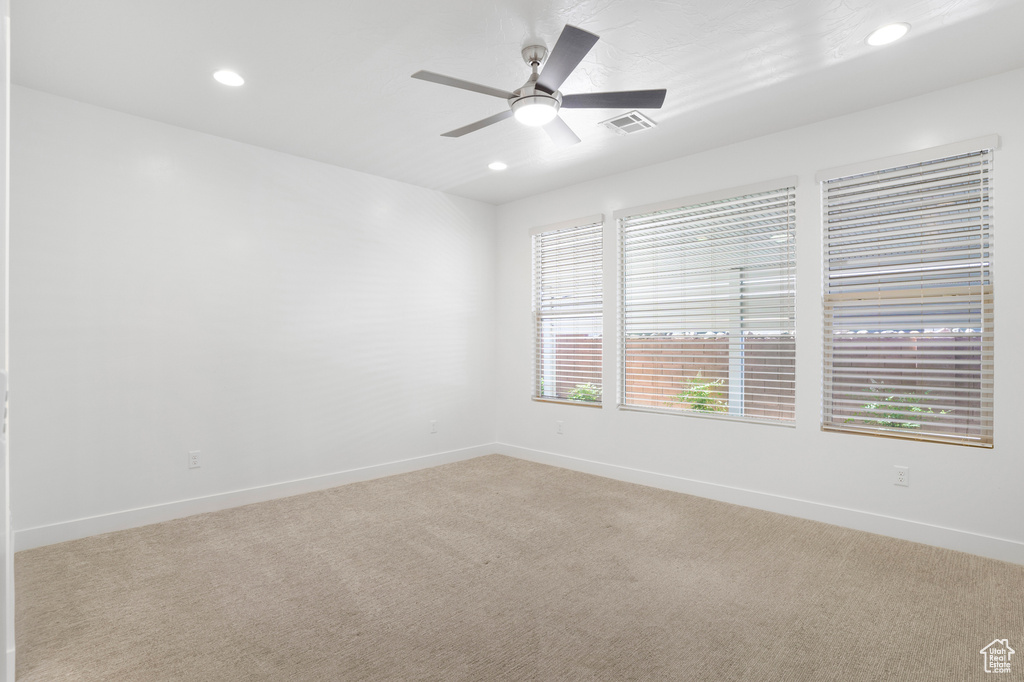 Empty room featuring recessed lighting, light carpet, ceiling fan, and baseboards