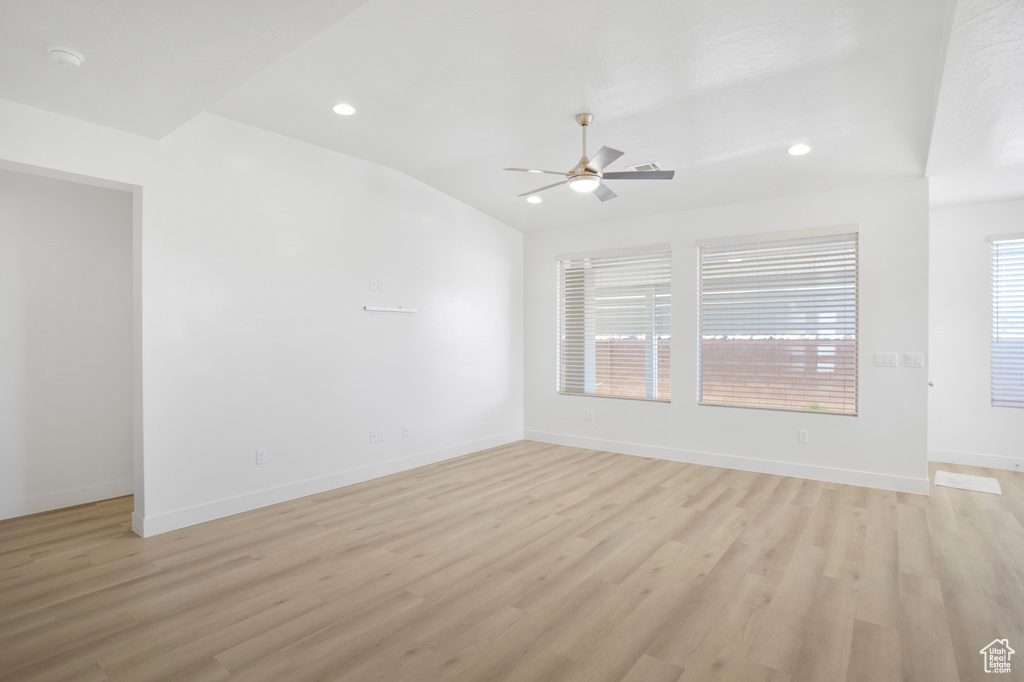 Unfurnished room featuring ceiling fan, light wood-style floors, baseboards, recessed lighting, and a smoke detector