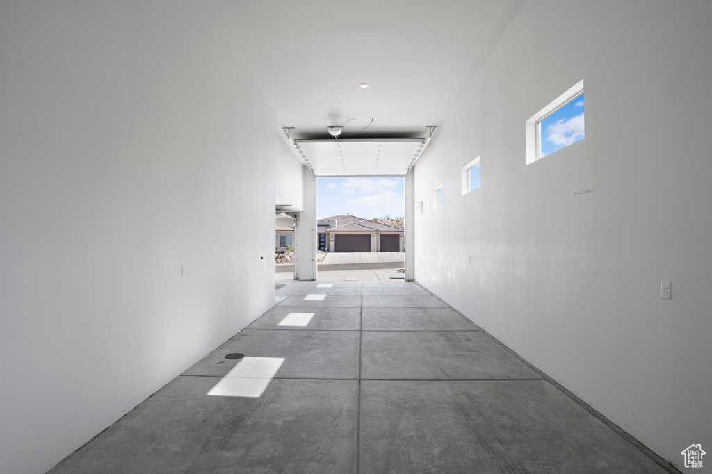 Hallway featuring concrete flooring and healthy amount of natural light
