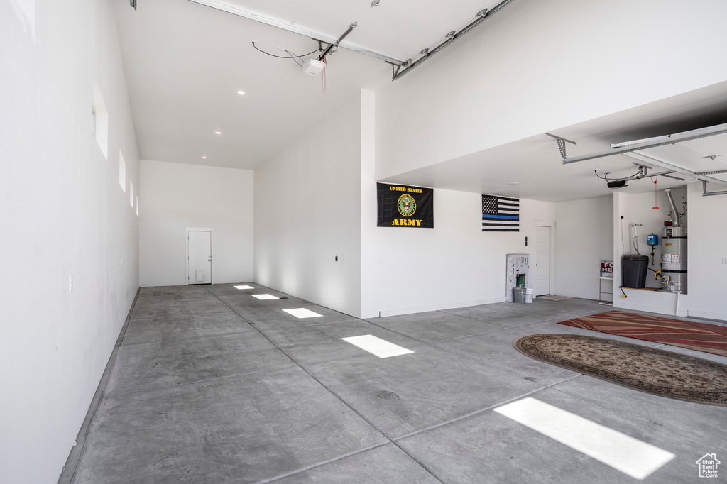Garage featuring a garage door opener and water heater