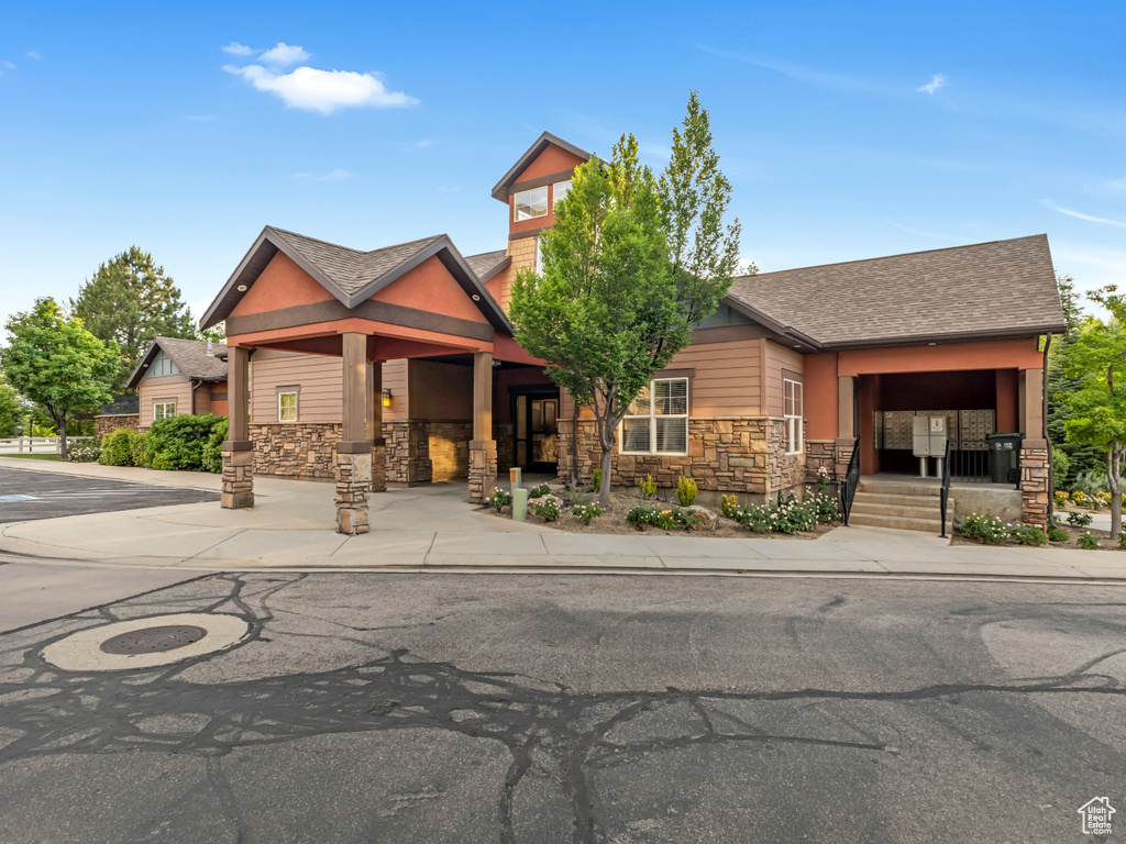 Craftsman inspired home with stone siding and a shingled roof