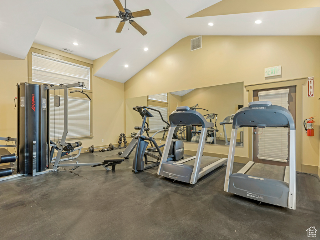 Workout area featuring ceiling fan, vaulted ceiling, and recessed lighting