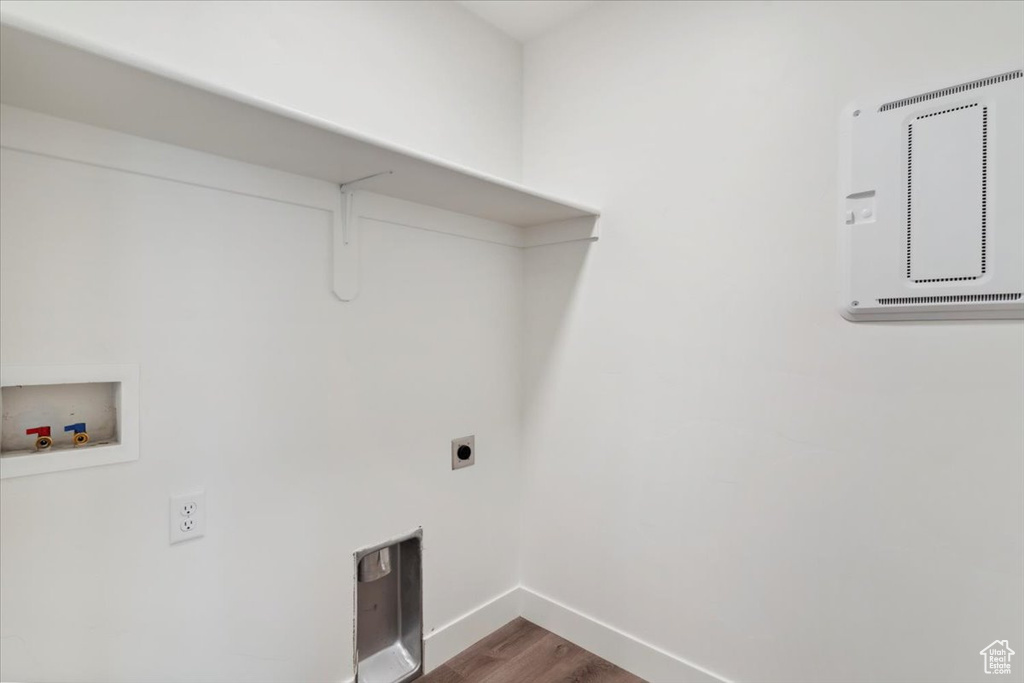 Laundry area with washer hookup, hookup for an electric dryer, baseboards, and wood finished floors