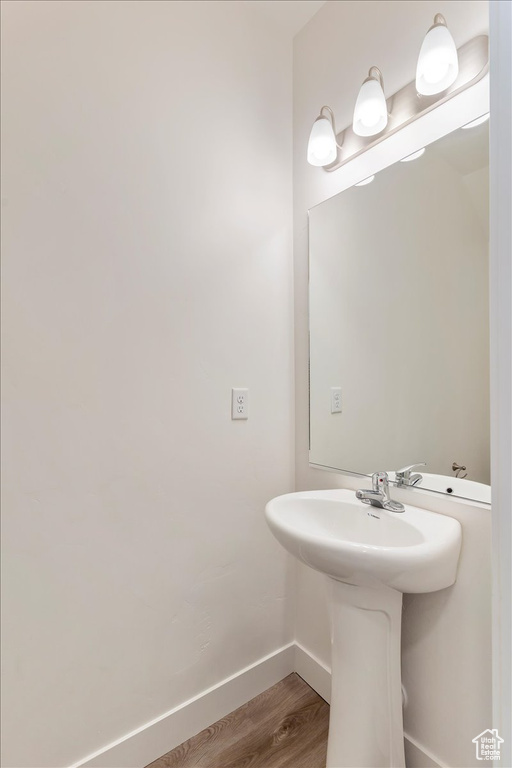 Bathroom with wood finished floors and baseboards