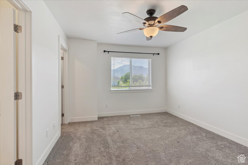 Unfurnished bedroom featuring carpet, baseboards, and ceiling fan