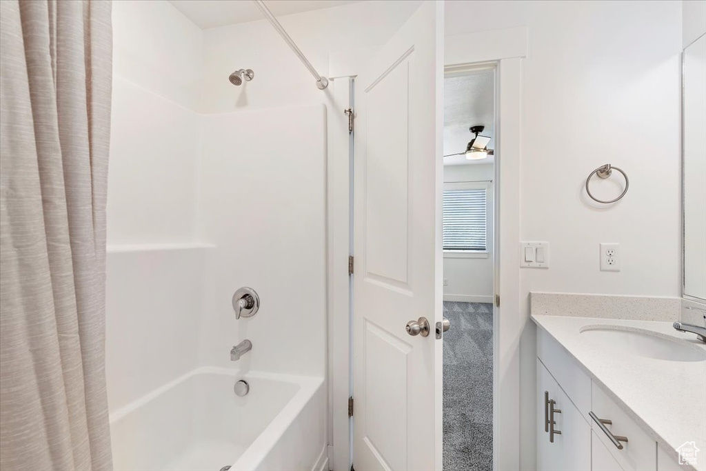 Bathroom with shower / bath combination with curtain and vanity
