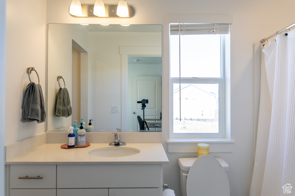 Full bath featuring vanity and toilet