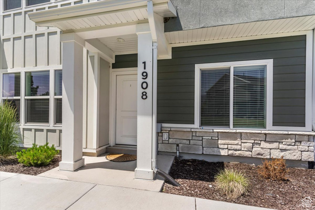 Doorway to property featuring board and batten siding