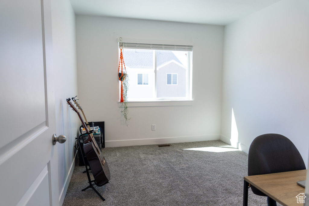 Office area featuring carpet floors and baseboards