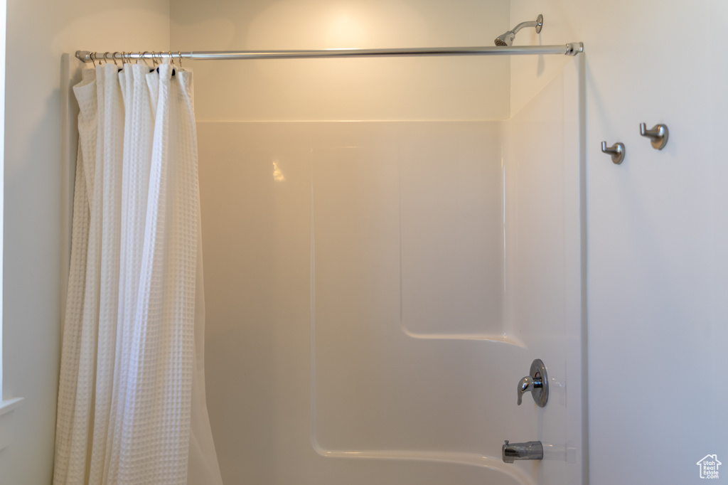 Full bathroom featuring shower / bathtub combination with curtain
