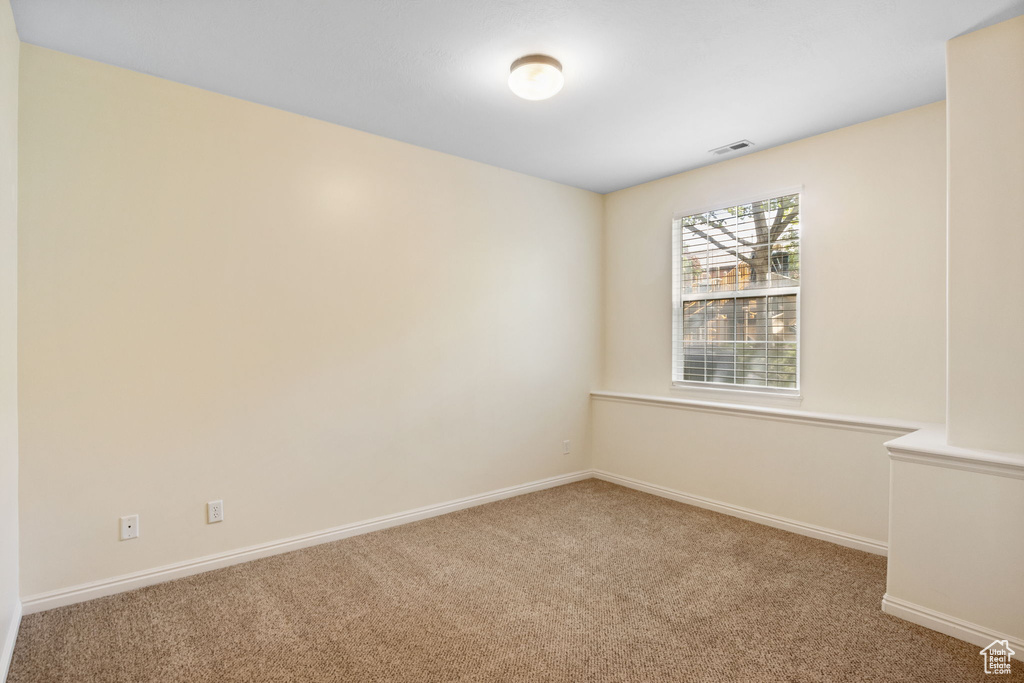 Unfurnished room featuring carpet flooring and baseboards