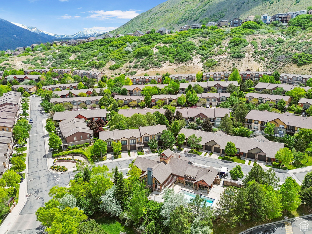 Aerial view of residential area featuring mountains and a pool area