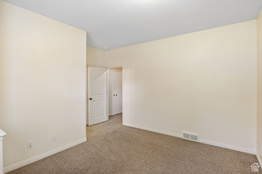 Empty room featuring carpet floors and baseboards