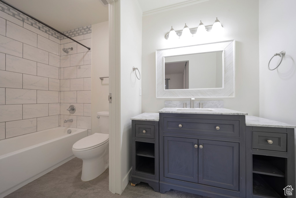 Bathroom featuring toilet, bathtub / shower combination, and vanity