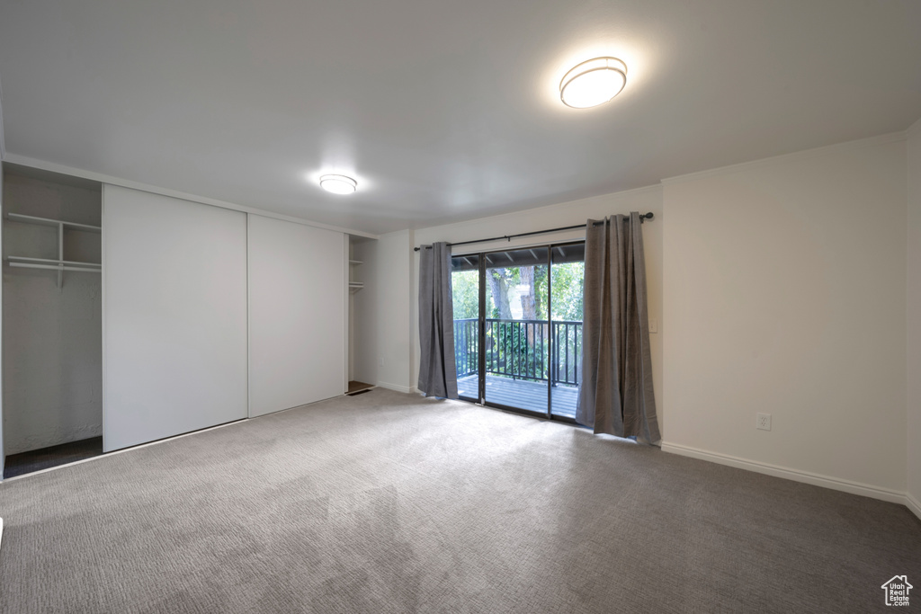 Carpeted spare room with baseboards