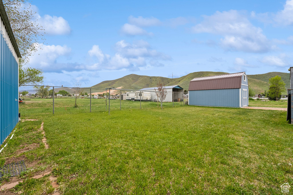 View of yard featuring a mountain view and an outbuilding