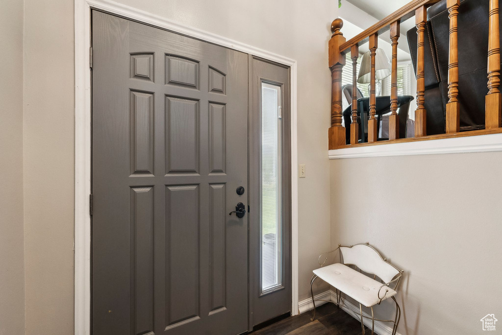 Entrance foyer featuring dark wood-type flooring and baseboards