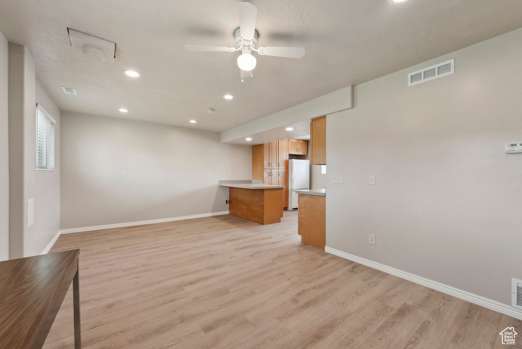 Unfurnished living room featuring recessed lighting, light wood finished floors, baseboards, and a ceiling fan