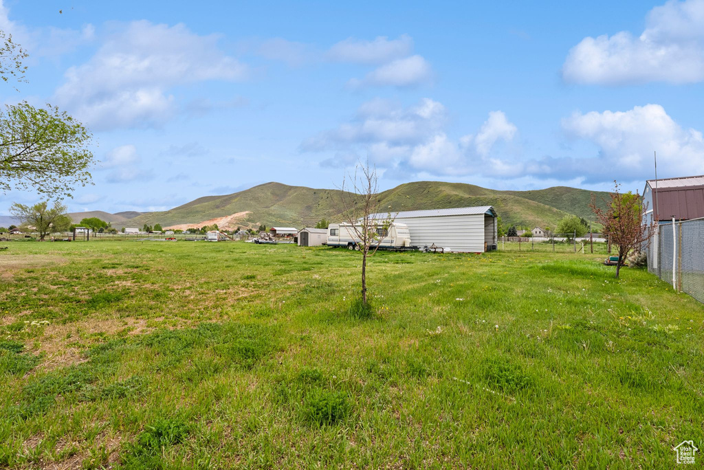 View of yard featuring a mountain view and an outbuilding