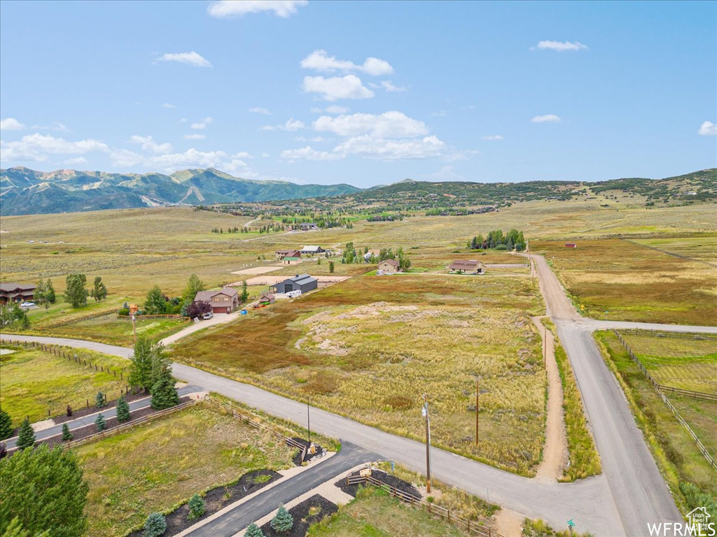 Overview of rural landscape featuring a mountainous background